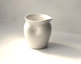 Porcelain dimple jug. Hand thrown in Scotland 180ml 9cm tall x 8cm wide. Dishwasher and microwave safe.