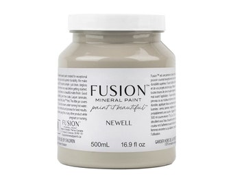 May include: A 16.9 fluid ounce bottle of Fusion Mineral Paint in the color Newell. The paint is a light beige color and is labeled with the Fusion logo and the color name.