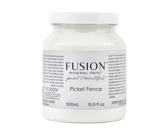 May include: A white, opaque bottle of Fusion Mineral Paint in the color Picket Fence. The bottle is labeled with the brand name, product name, and volume: 500mL (16.9 fl oz).