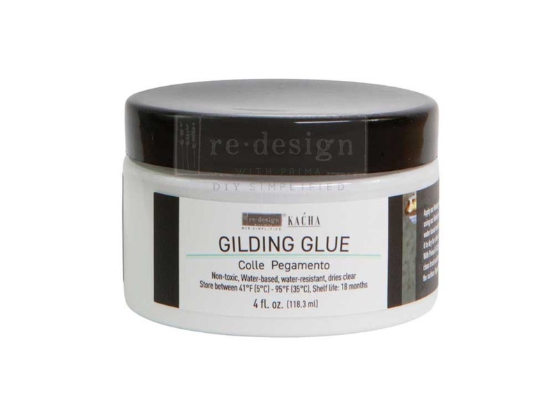 May include: A white jar of gilding glue with a black lid. The label reads "GILDING GLUE" and "4 fl. oz. (118.3 ml)." The glue is water-based, non-toxic, and water-resistant. The product is from "re-design with Prima."
