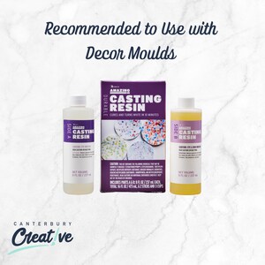 May include: Three bottles and a box of Amazing Casting Resin. The bottles are labeled Side A and Side B, each containing 237 ml. The box is purple and white, with the text "Cures and turns white in 10 minutes."