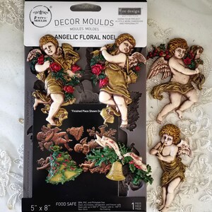 May include: A black mold package with the text "DECOR MOULDS" and "ANGELIC FLORAL NOEL" features cherub designs. The package is 5" x 8" and includes cherub figures holding roses and a Christmas tree. The finished pieces are shown.