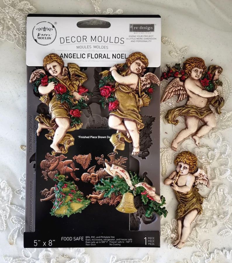 May include: A black mold package with the text "DECOR MOULDS" and "ANGELIC FLORAL NOEL" features cherub designs. The package is 5" x 8" and includes cherub figures holding roses and a Christmas tree. The finished pieces are shown.