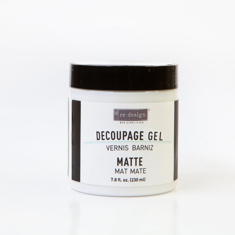 May include: A white jar of Re-Design Decoupage Gel with a black lid. The label reads "Decoupage Gel, Vernis Barniz, Matte, Mat Mate, 7.8 fl. oz. (230 ml)"