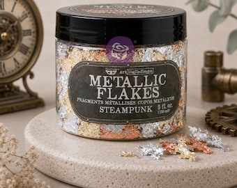 May include: A clear plastic jar with a black lid containing metallic flakes in gold, silver, and copper colors. The label reads Metallic Flakes Steampunk 5 fl. oz. (150 ml). Several loose flakes are scattered on the surface in front of the jar.