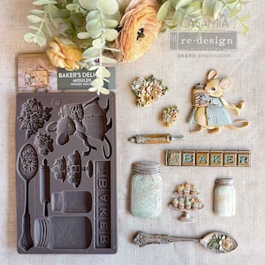 May include: A collection of baking-themed decorative elements. Includes a silicone mold with various kitchen tools and floral designs, along with individual decorative pieces such as a mouse, jars, and a spoon. The color palette features soft browns, greens, and creams.