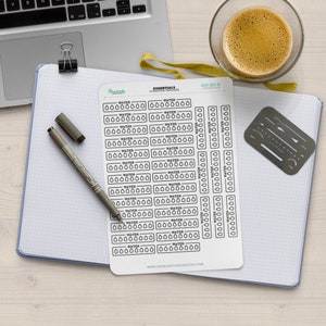 May include: A sheet of black and white water tracker stickers with the text "ESSENTIALS HYDRATION TRACKERS" and "WATER" repeated multiple times. The stickers are designed to be used in a planner or journal.