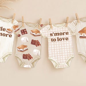 May include: Four baby bodysuits hanging on a string with wooden clips. The garments feature brown text reading little more and s'more to love, alongside watercolor illustrations of chocolate squares, marshmallows, and s'mores on striped and plaid patterns.