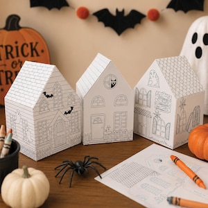 Halloween paper house village made with printable coloring houses displayed as handmade Halloween decor and kids paper toy DIY.