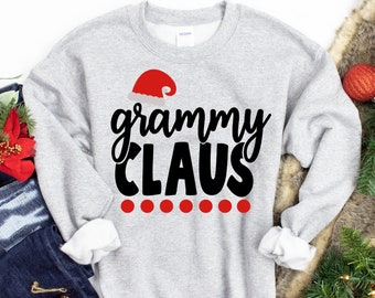 May include: A gray sweatshirt with the text "grammy claus" in black lettering and a red Santa hat graphic. There are five red dots below the text.