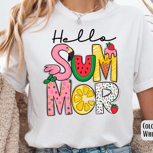 May include: White t-shirt with a colorful graphic that says "Hello Summer" with a flamingo, watermelon, lemon, ice cream cone, and sprinkles.
