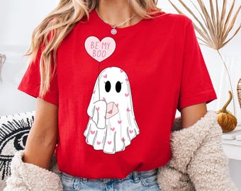 May include: Red t-shirt with a white ghost holding a pink envelope and a pink heart balloon that says "Be My Boo".