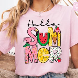 May include: Pink t-shirt with the text "Hello Summer" in colorful letters. The letters are decorated with a flamingo, watermelon, ice cream cone, lemon, and sprinkles.