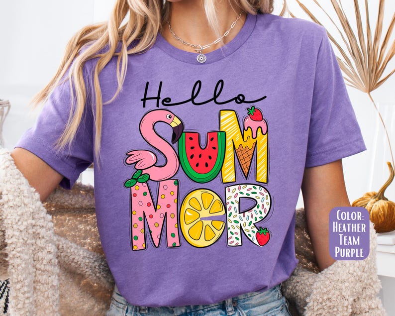 May include: Purple t-shirt with the text "Hello Summer" in colorful letters. The letters are decorated with a flamingo, watermelon, ice cream cone, lemon, and sprinkles.
