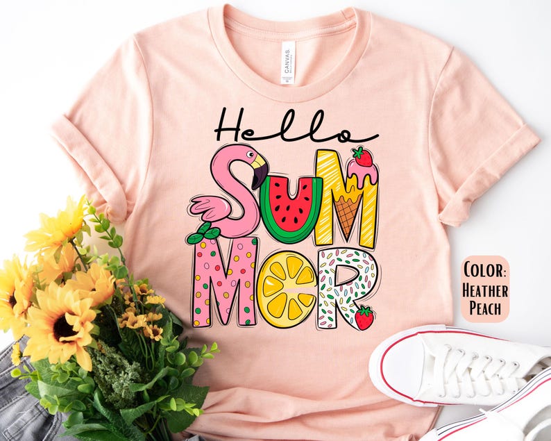 May include: A pink t-shirt with the text "Hello Summer" in colorful letters. The letters are decorated with images of a flamingo, watermelon, ice cream cone, lemon, and strawberries.