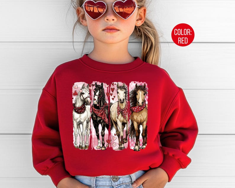 May include: A red sweatshirt with a graphic of four horses, each with a different coat colour and wearing a red bandana. The horses are set against a white background with pink hearts. The text "COLOR: RED" is in a red circle.