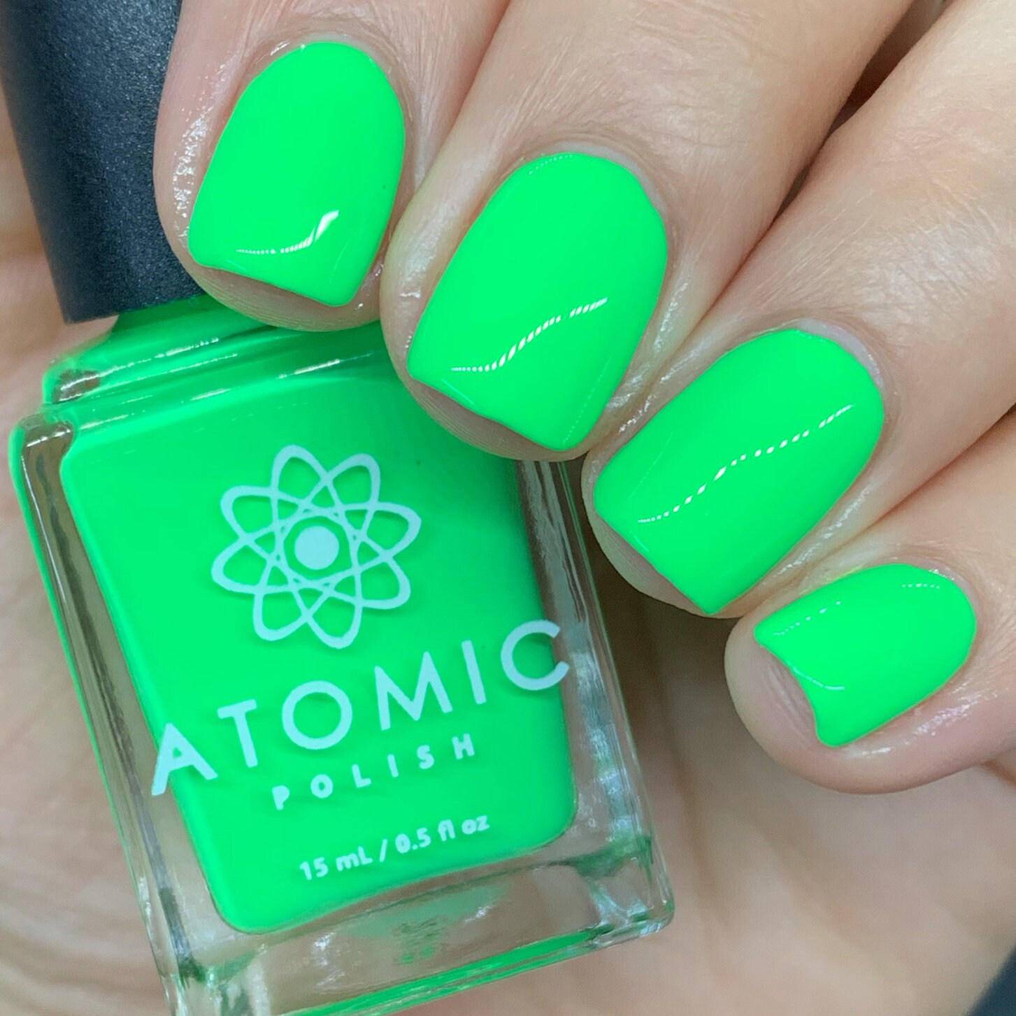 Female hand with long nails and neon green manicure with bottles of nail  polish Stock Photo | Adobe Stock