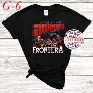 May include: Black t-shirt with a graphic of a band called "Grupo Frontera" with the text "Jurando" and "Tour" in red and white. The band members are wearing black and white clothing and are standing in front of a red and white background.