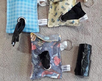 Fabric 'poo' bag holder.  Made from fun beautiful fabric.  Room for 2 poo bag rolls. Comes with hanging tag