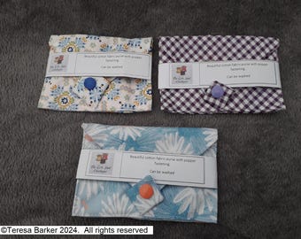 Poppered fabric purses.  Beautiful detail on front, two pockets inside.  Easily fits credit cards, business cards, and folded notes
