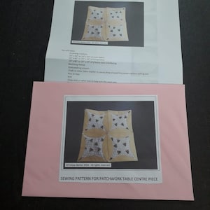 May include: A sewing pattern for a patchwork table centre piece. The pattern features a yellow and white fabric with a geometric design. The pattern is printed on a white sheet of paper with the text "Sewing Pattern for Patchwork Table Centre Piece" printed at the bottom.