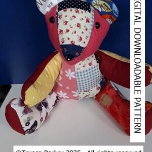 May include: A patchwork teddy bear with a pink body, yellow arms, and red legs. The bear has black button eyes and a black nose. The bear is sitting on a blue background.
