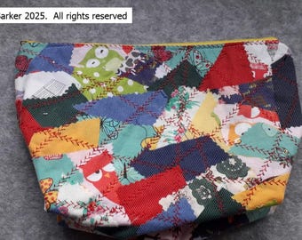 A beautiful patchwork fabric purse/pouch with top zip closure.  Fabric has been handmade