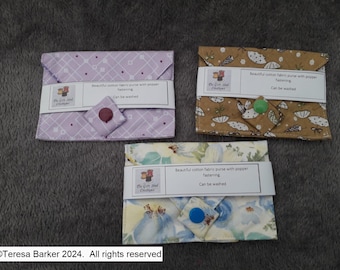 Poppered fabric purses.  Beautiful detail on front, two pockets inside.  Easily fits credit cards, business cards, and folded notes