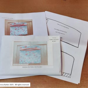 May include: A sewing pattern for a peg bag, with a blue fabric design and red accents, pattern number #1043. The image includes pattern pieces and the text "SEWING PATTERN FOR PEG BAG". Copyright Teresa Barker 2025.