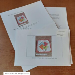 May include: A sewing pattern for a patchwork table mat. The pattern features a colour image of the finished product, a square mat with a colourful geometric design. The pattern is labelled with the text "Patchwork Table Mat Pattern Number #1042".