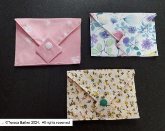 Poppered fabric purses.  Beautiful detail on front, two pockets inside.  Easily fits credit cards, business cards, and folded notes