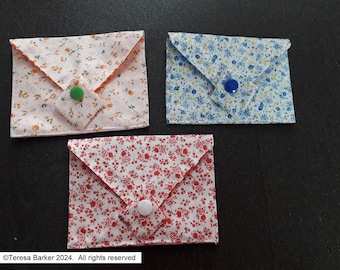 Poppered fabric purses.  Beautiful detail on front, two pockets inside.  Easily fits credit cards, business cards, and folded notes