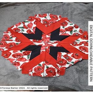 May include: A red, white and black quilt block with a star design. The fabric features a poppy print. The text "DIGITAL DOWNLOADABLE PATTERN" is visible on the right side of the image.