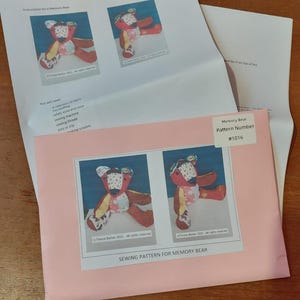 May include: A Memory Bear sewing pattern with images of a patchwork teddy bear. The pattern includes instructions and a list of materials needed. The pink envelope is labelled "SEWING PATTERN FOR MEMORY BEAR" and "Memory Bear Pattern Number #1016".