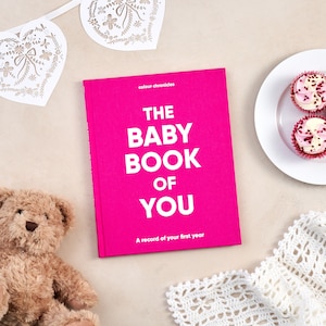Celebrate the arrival of a baby with this inclusive baby record journal, a perfect baby shower gift for all families. Baby memory journal shown in pink cloth covered hard backed book, new baby gift.