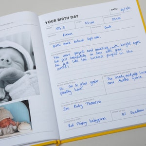 Showing the baby book of you filled out with memories of the birth day. Included are photos of the new baby and memories from the day. This baby journal is designed for all families and babies capturing memories of the first year for the new baby.