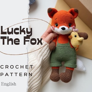 May include: A crocheted fox doll with orange fur, brown ears and boots, and green overalls. The fox holds a yellow crocheted chick. The text "Lucky The Fox" and "CROCHET PATTERN" are visible.