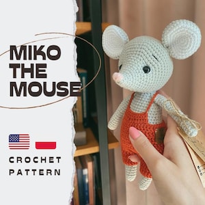 May include: A light gray crocheted mouse toy with large round ears, a small pink nose, and black eyes, wearing orange overalls. The image features the text MIKO THE MOUSE and CROCHET PATTERN, along with a small American flag and a Polish flag icon.