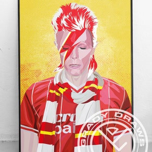 May include: A digital illustration of David Bowie wearing a red and white soccer jersey with a red and yellow scarf. The background is yellow. The text "Grady Draws" is in a circle at the bottom right corner of the image.