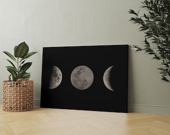 May include: A black and white canvas print featuring three different phases of the moon on a black background.