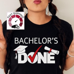 May include: Black t-shirt with the text "Bachelor's Done" in white, featuring a graduation cap, checkmark, and diploma. The image includes a logo with a truck and the words "Fast Shipping".