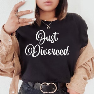 May include: Black t-shirt with the text "Just Divorced" in white cursive lettering.