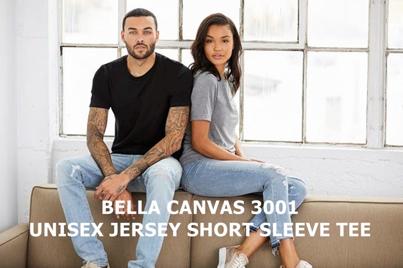 May include: Two people are wearing Bella Canvas 3001 Unisex Jersey Short Sleeve Tees. The person on the left is wearing a black tee and the person on the right is wearing a gray tee. Both are wearing blue jeans.