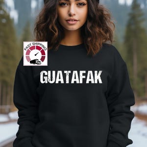 May include: Black sweatshirt with white text that reads "GUATAFAK" and a small graphic of a truck with a speedometer that says "FAST SHIPPING".