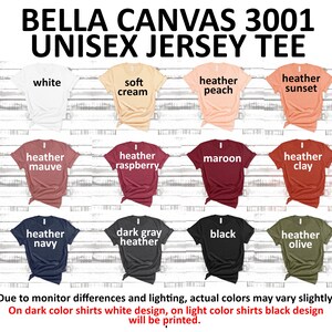 May include: A Bella Canvas 3001 unisex jersey tee in various colors, including white, soft cream, heather peach, heather sunset, heather mauve, heather raspberry, maroon, heather clay, heather navy, dark gray heather, black, and heather olive. The text "BELLA CANVAS 3001 UNISEX JERSEY TEE" is at the top of the image. The text "Due to monitor differences and lighting, actual colors may vary slightly. On dark color shirts white design, on light color shirts black design will be printed." is at the bottom of the image.
