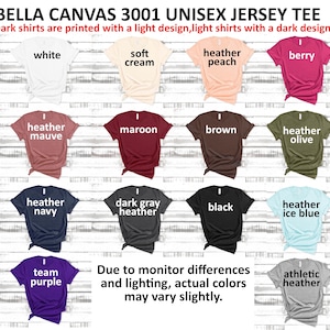 May include: A display of Bella Canvas 3001 Unisex Jersey Tees in various colors, including white, soft cream, heather peach, berry, heather mauve, maroon, brown, heather olive, heather navy, dark gray heather, black, heather ice blue, team purple, and athletic heather.