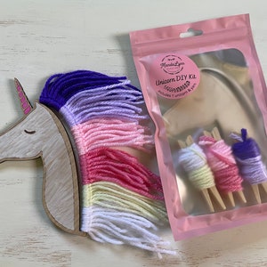 May include: A unicorn DIY kit with a wooden unicorn head and yarn in purple, lavender, pink, yellow, and white colors. The kit includes 1 unicorn and yarn.