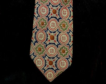 May include: A patterned tie with a blue background and red, white, and green geometric designs.