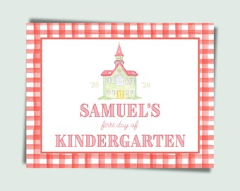 May include: A rectangular sign with a red and white gingham border. The sign features a watercolor illustration of a schoolhouse and the text "SAMUEL'S first day of KINDERGARTEN". The years '25 and '26 are on either side of the schoolhouse.