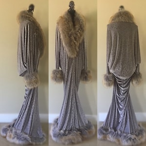 May include: A long, gray velvet robe with a faux fur collar, cuffs, and trim. The robe has a fitted bodice and a flowing skirt.